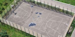 Picture of a basketball, volleyball combination asphalt sports court.