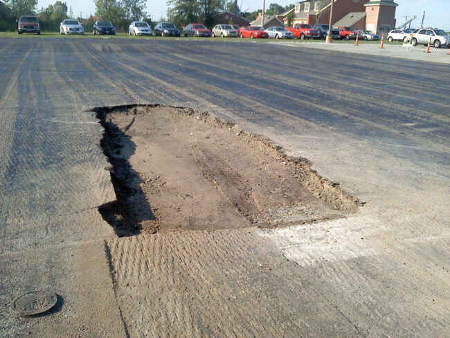 A picture of an asphalt parking lot being repaired
