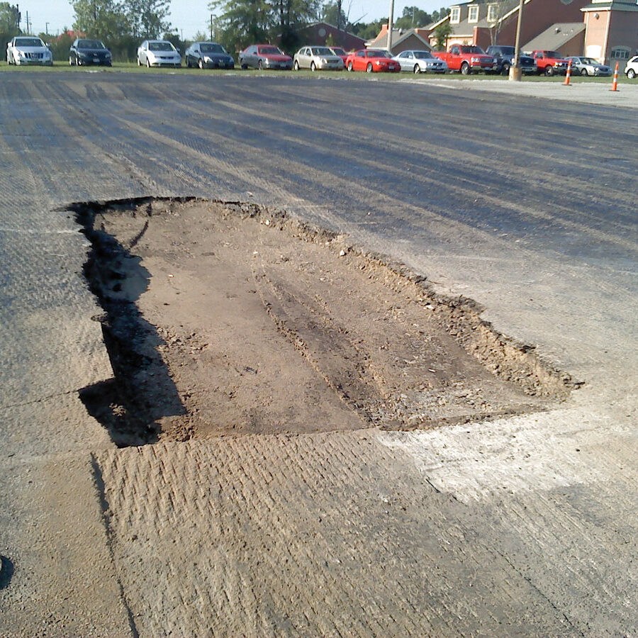 A picture of an asphalt parking lot being repaired