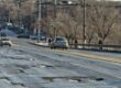Potholes - A picture of a city street with terrible pothole damage.